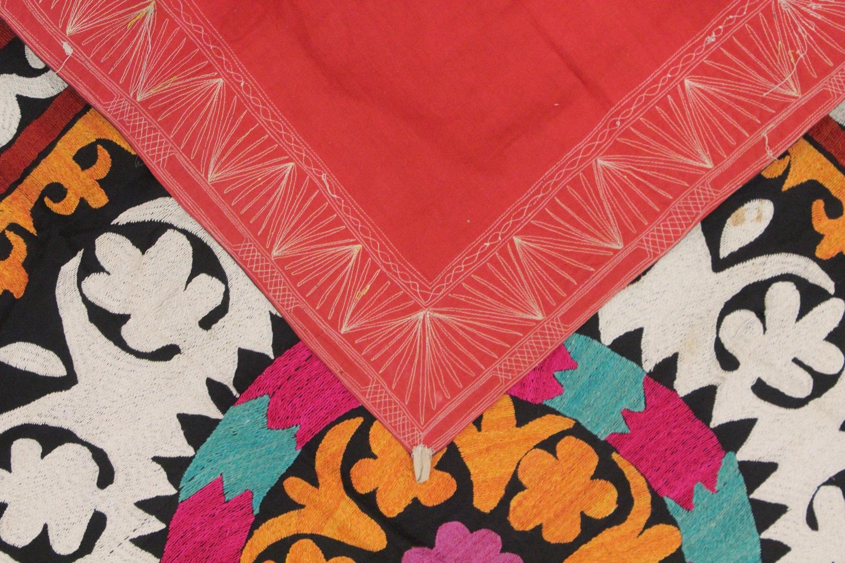 AN UZBEK SUZANI EMBROIDERED TEXTILE, with central foliate motif in orange, pink, red, green, - Image 3 of 3