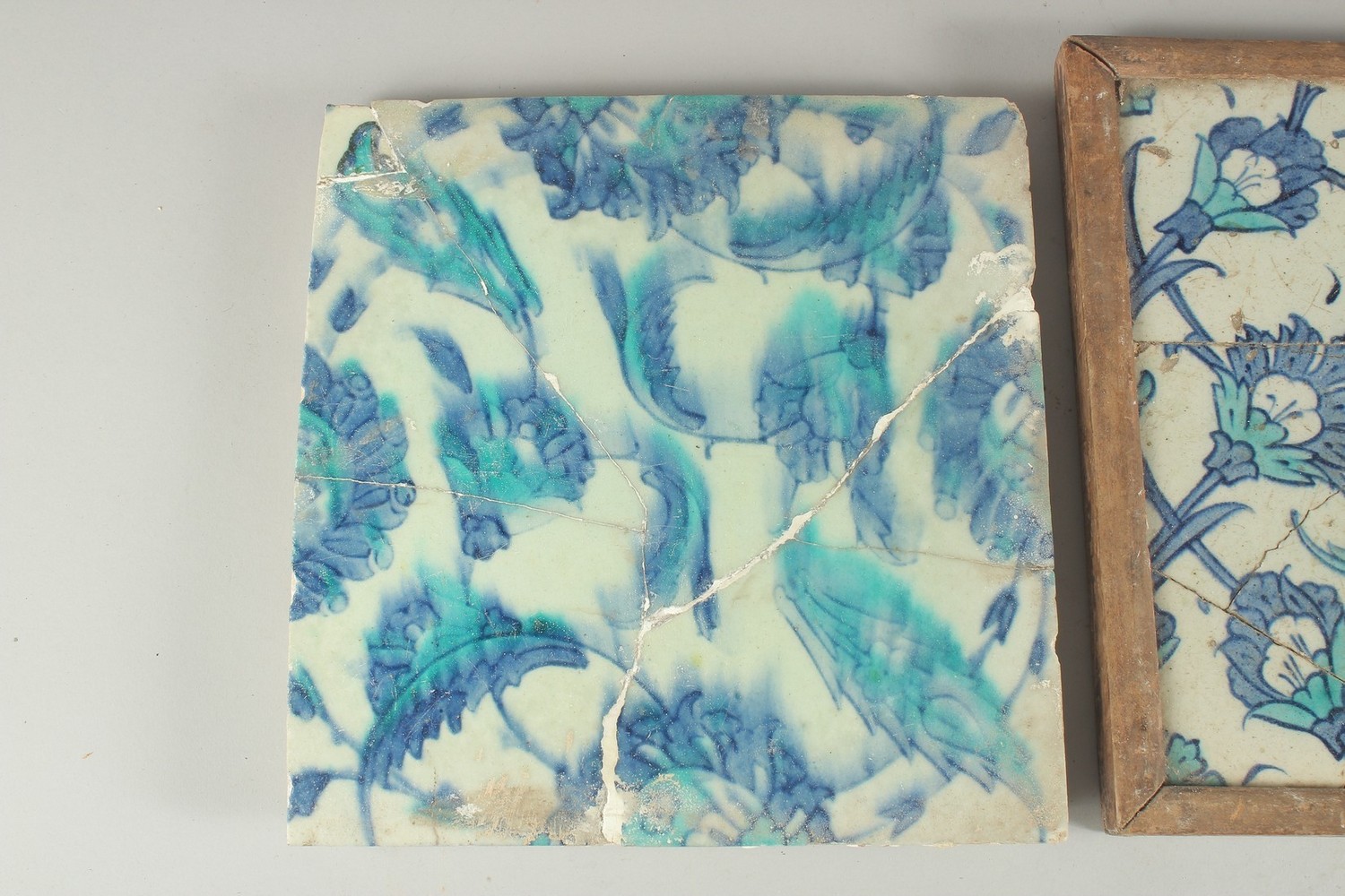 TWO EARLY 17TH CENTURY OTTOMAN IZNIK BLUE AND WHITE GLAZED POTTERY TILES, each approx. 25cm - Image 2 of 4