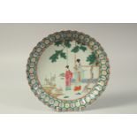 A CHINESE FAMILLE ROSE PORCELAIN PLATE, painted with female figures in a garden, the base with