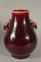 A CHINESE OX BLOOD GLAZE PORCELAIN VASE, with dear head handles, character mark to base, 30cm high.