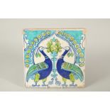 AN UNUSUAL 19TH CENTURY NORTH INDIAN MULTAN GLAZED POTTERY TILE, depicting two peacocks, 30cm x 30.