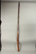 A LONG INDIAN MATCHLOCK RIFLE, 186cm long.