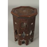 A MOORISH MOTHER OF PEARL INLAID CARVED WOOD HEXAGONAL TABLE, 47cm high.