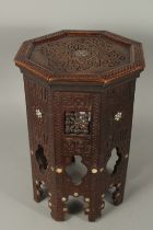 A MOORISH MOTHER OF PEARL INLAID CARVED WOOD HEXAGONAL TABLE, 47cm high.