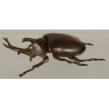 A BRONZE OKIMONO OF A RHINO BEETLE, with removable wings, 9cm long.