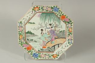 A JAPANESE TAISHO ERA OCTAGONAL PORCELAIN CHARGER. painted with ladies on a bridge, 33cm at widest