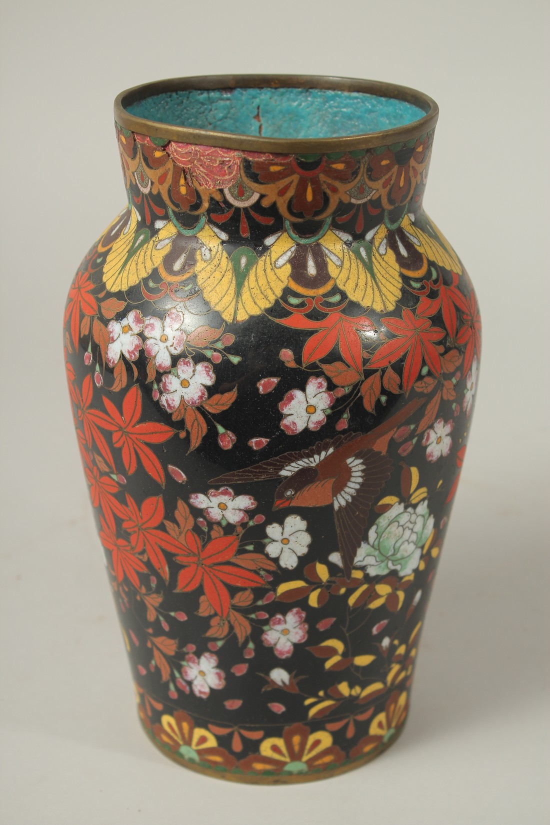 A CHINESE BLACK GROUND CLOISONNE VASE, decorated with birds and flora, (af), 24cm high.