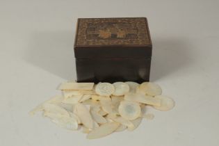 A COLLECTION OF CHINESE ETCHED MOTHER OF PEARL GAMING COUNTERS IN A GILT AND BLACK LACQUER BOX,