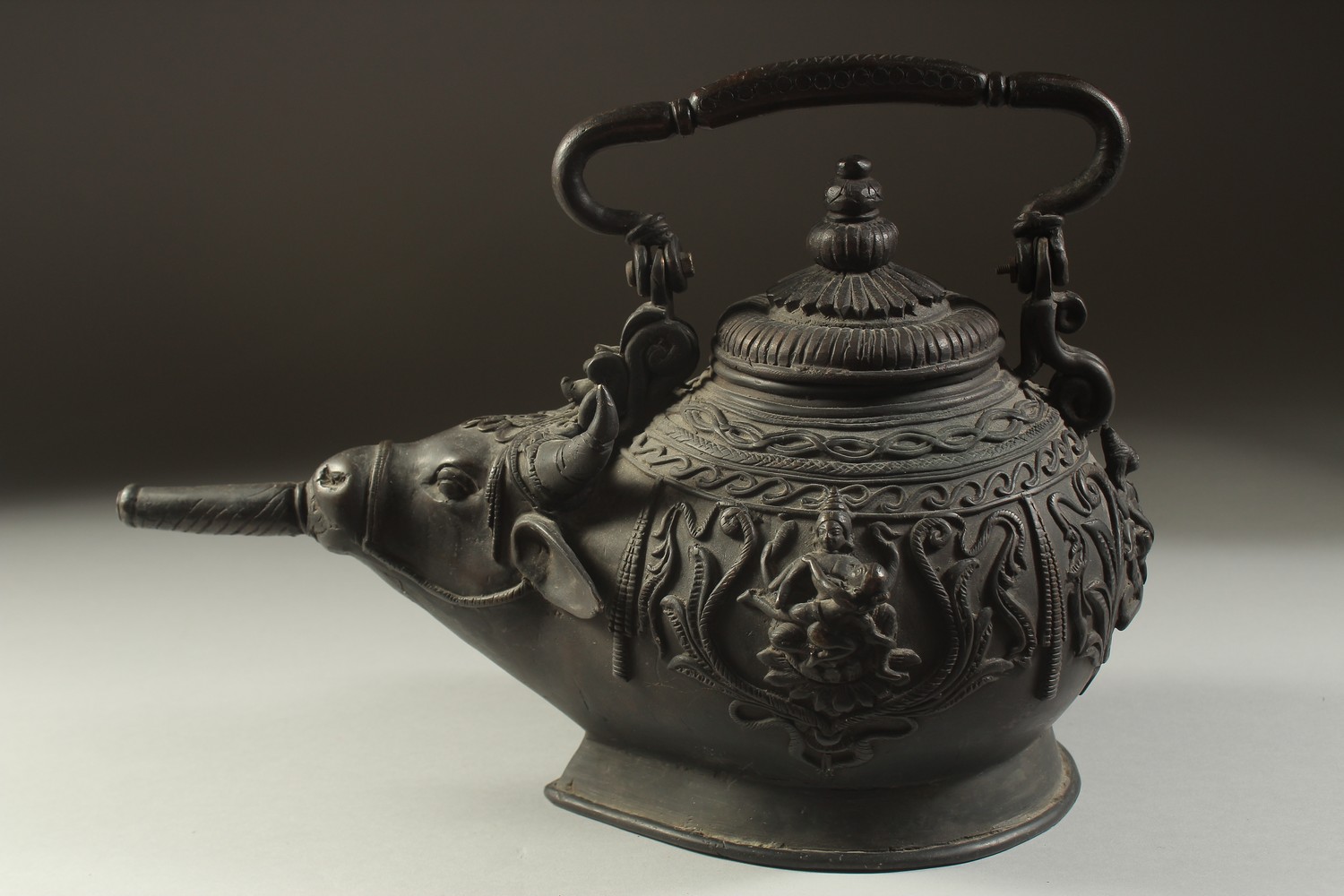 A FINE AND UNUSUAL INDIAN BRONZE EWER, with bulls' head spout and relief hindu deities around the - Image 4 of 5