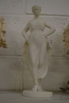 Carved alabaster figure of a standing female.