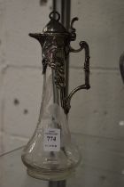 A small Art Nouveau pewter and engraved glass claret jug.