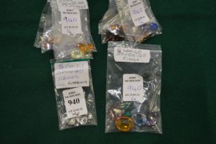 Four packets of clear and decorative stones.