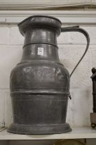 A very large pewter flagon.