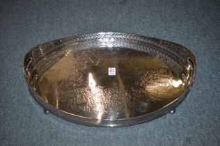 A large plated twin handled galleried tray with engraved decoration.