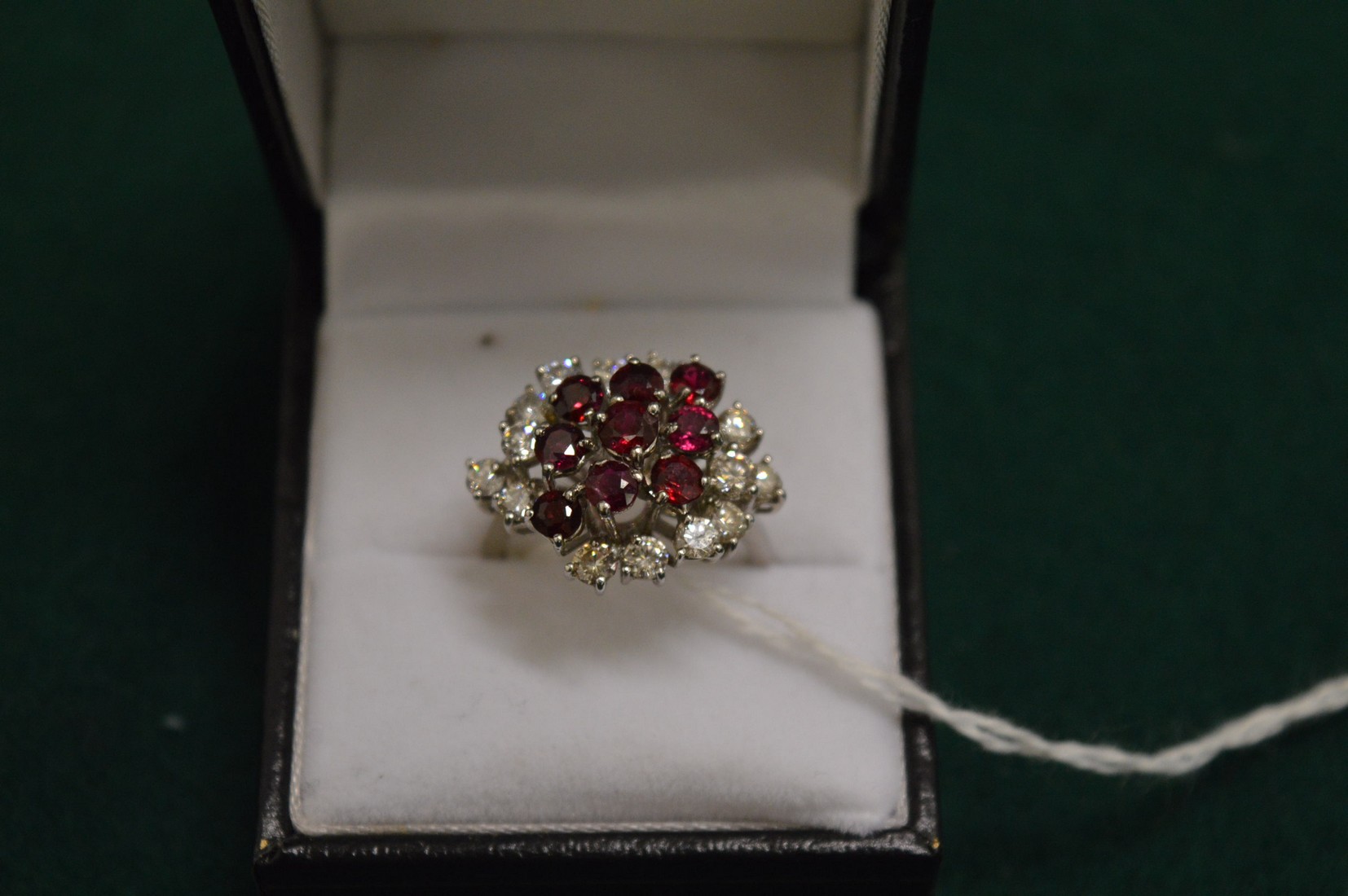 An 18ct white gold diamond and ruby cluster ring.