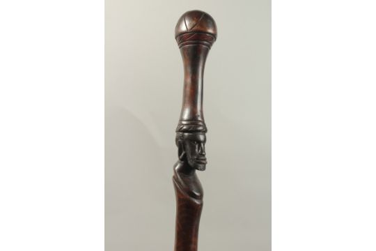 A CEREMONIAL STICK with carved head. 100cms long. - Image 1 of 4