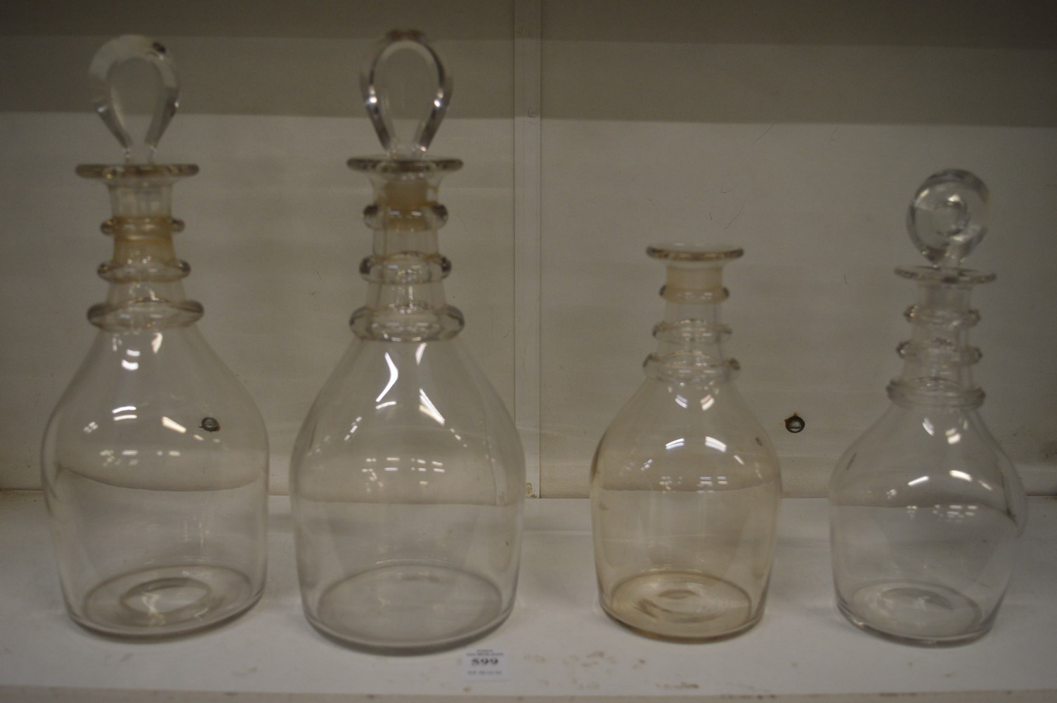 Two pairs of ring neck decanters, one lacking stopper.