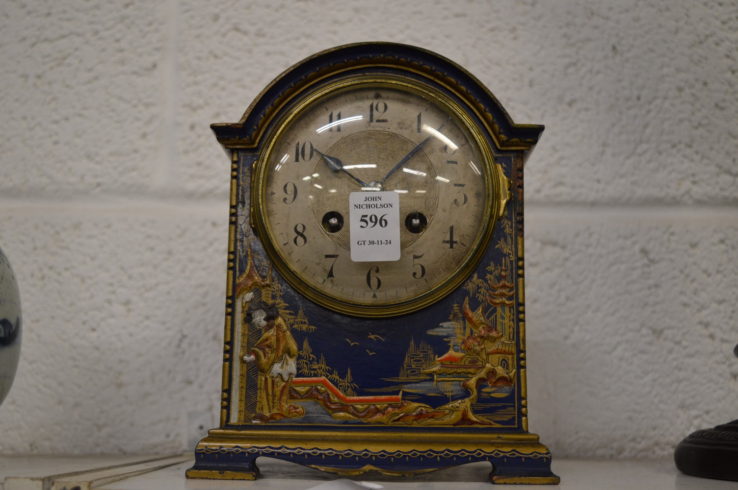 An Asprey retailed chinoiserie decorated mantel clock.