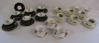 Collection of cups and saucers includes Foley black and gold floral trios, Royal Sutherland (5