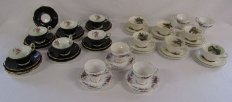 Collection of cups and saucers includes Foley black and gold floral trios, Royal Sutherland (5