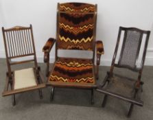 3 folding chairs - cane back and seat, covered seat with inlay design and larger upholstered chair