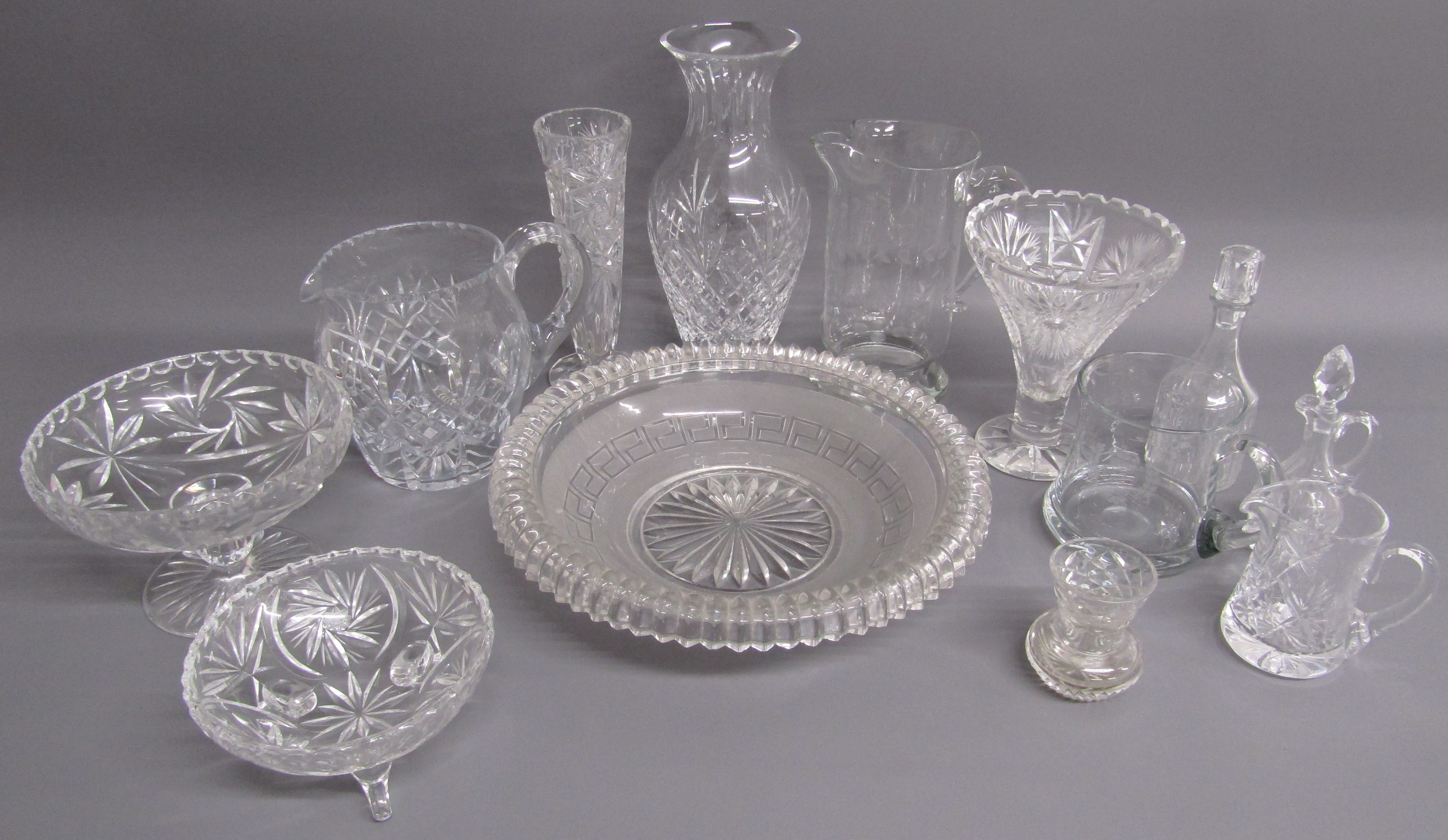 Collection of crystal and glassware includes vases, jugs and a large dish