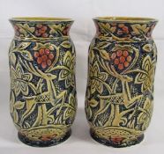 Pair of vases marked England with stag, trees and red berries design on a blue background -