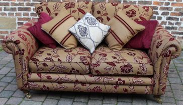 Modern sofa with floral pattern design on castors with scatter cushions L 180cm D 100cm Ht 90cm