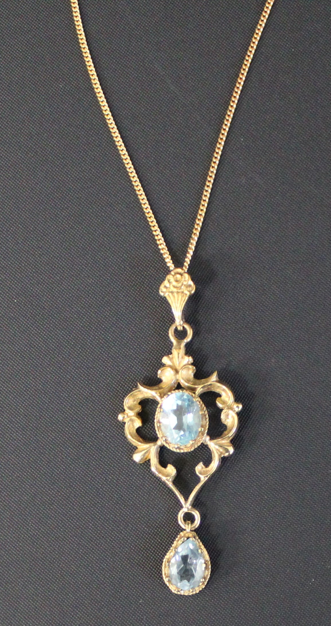 Tested as 9ct gold aquamarine pendant (4.80g) on 9ct gold chain (2.26g)