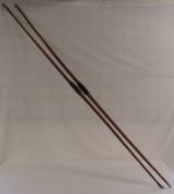 2 patinated long bows one with red velvet handle marked Madle, Firth St, London - approx. 187cm
