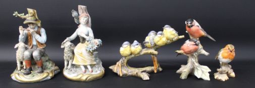 Pair of Capodimonte porcelain figurines - boy and girl seated with sheep 19cm high and three Italian