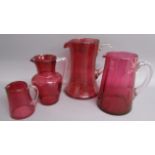 4 Cranberry glass jugs (one with chip to rim)