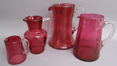 4 Cranberry glass jugs (one with chip to rim)