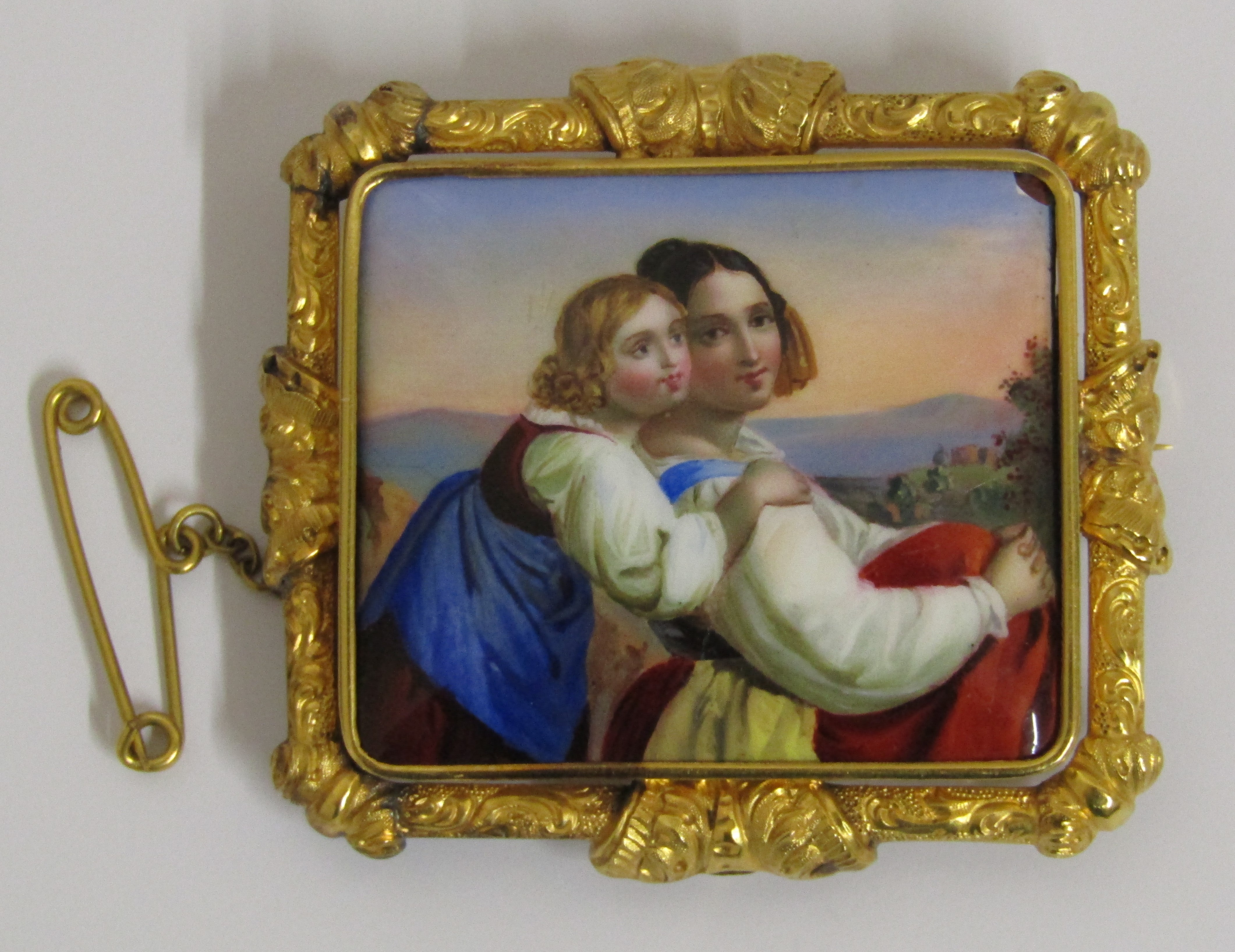 Tested as possibly 15ct gold mounted hand painted brooch depicting mother & child  (slight damage to