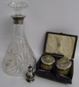 Cut glass decanter with silver collar B.P Co London 1932, pair William Henry Leather Birmingham 1925