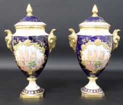 Pair of Coalport rams head lidded vases with hand painted and gilded scenes depicting Lincoln