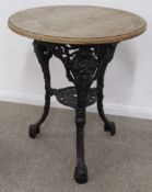 Cast iron pub table with head motifs