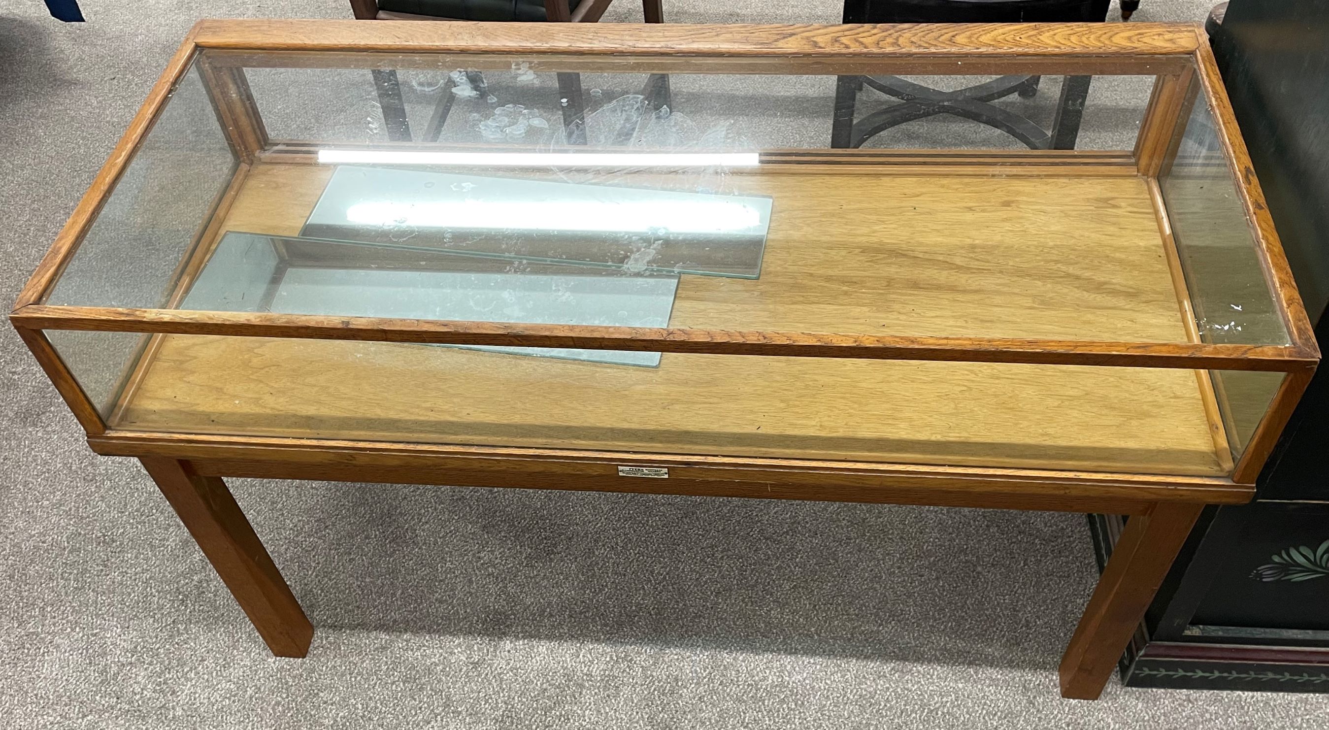 Mid 20th century low level display counter (missing doors) L 122cm W 53cm Ht 72cm