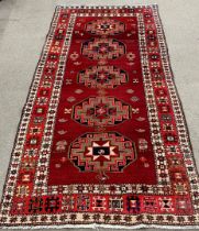 Rusty red multi-coloured  field full pile Persian runner with medallion design 287cm by 160cm