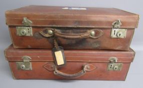 Pair of leather suitcases with travel stickers for New York 1965 & 1969 and matching travel names