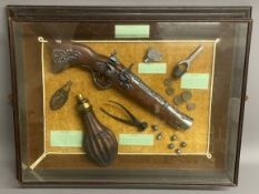 Replica flintlock pistol & accessories in a display case