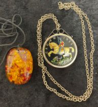 Enameled five shilling piece pendant on a chain & an amber type pendant