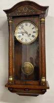 Early 20th century wall clock in an oak case Ht 72cm W 33cm D 18cm