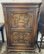 Large 20th century oak corner cupboard with carved panels