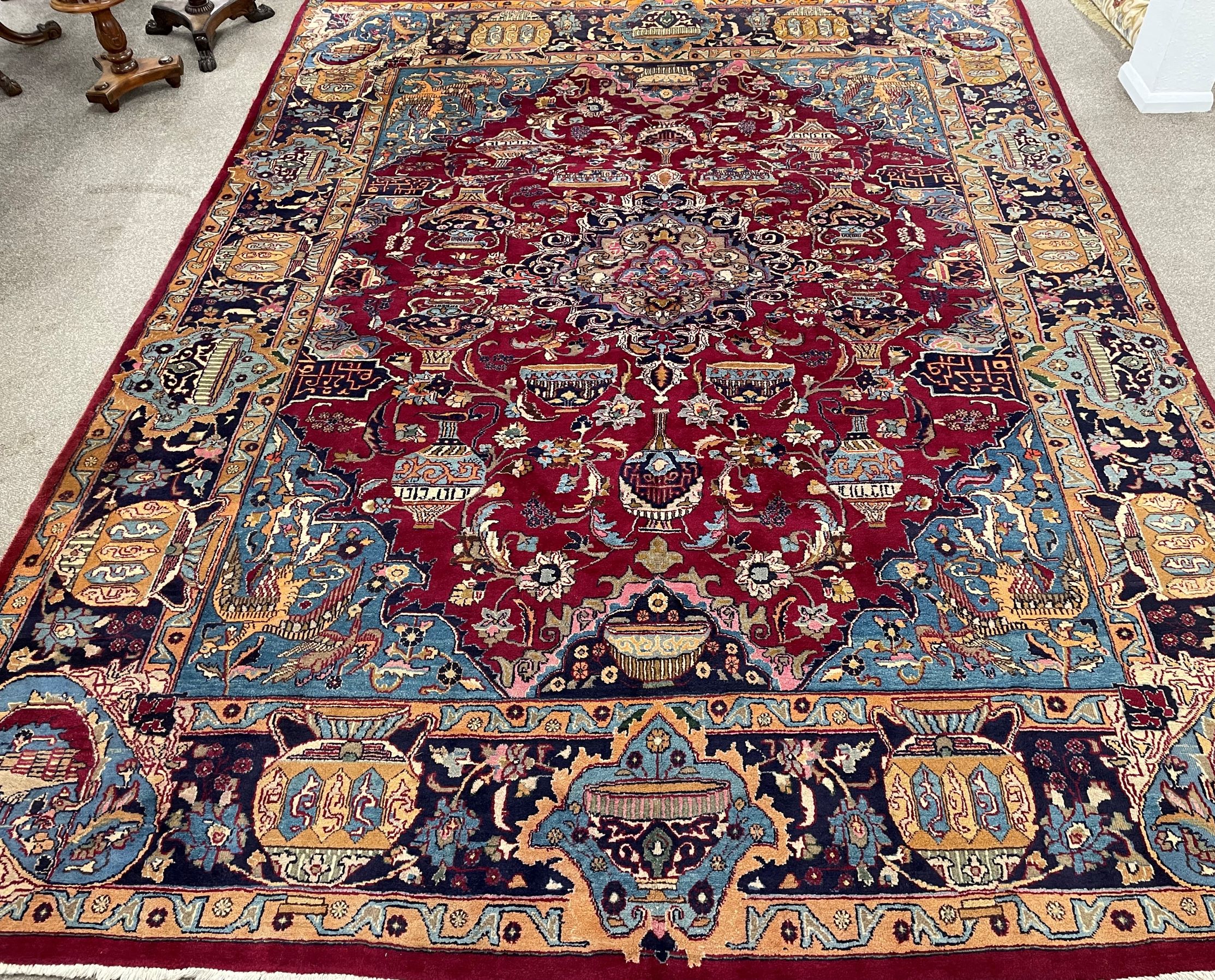 Large claret ground Persian Kashmar carpet with unique under earth design depicting vases & bowls