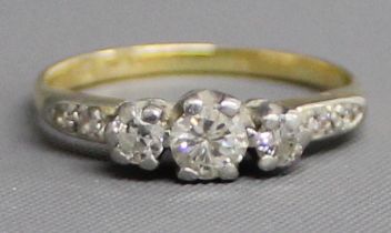 18ct gold, platinum set three stone diamond ring with diamond set shoulders, 2.52g, size I