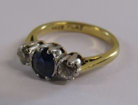 18ct gold ring with platinum mount and set with central sapphire flanked by two 1/8ct diamonds -
