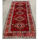 Rusty red multi-coloured  field full pile Persian runner with medallion design 287cm by 160cm