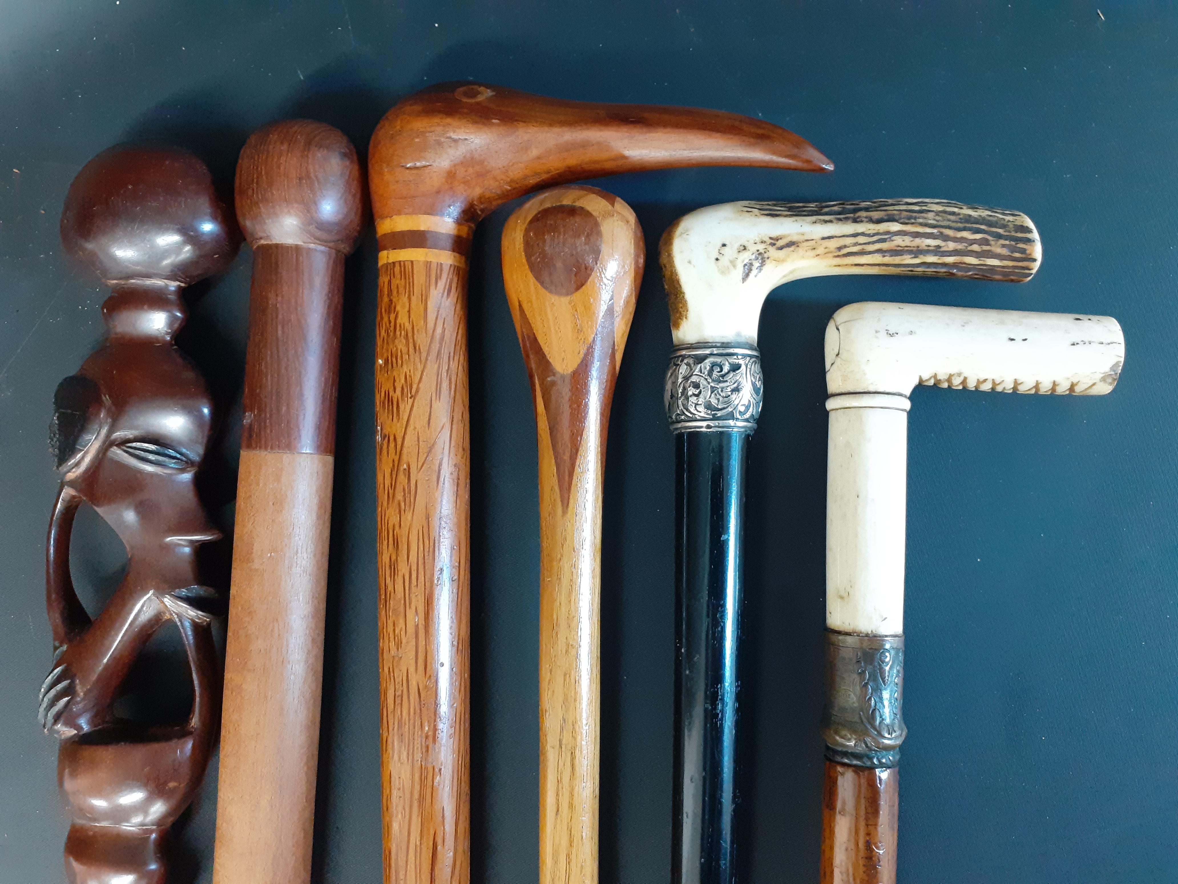 Selection of walking sticks including horn handle with silver collar & carved bone handled stick