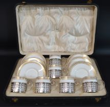 Cased set of Wedgwood coffee cans & saucers (pattern number Z4961) with pierced silver holders,